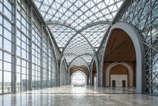 Terminal-scale vaulted glass roof and curtain wall